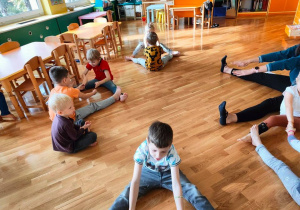 Zajęcia wg metody RR W. Sherborne w grupie 4. Zabawy w parach - dzieci siedzą naprzeciw siebie w siadzie rozkrocznym i trzymają się za dłonie.