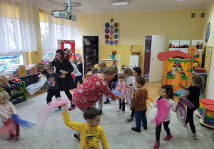 Choreoterapia grupa 3. Na zdjęciu widać grupę dzieci tańczących z kolorowymi chustami.