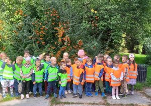 Dzieci stoją na tle krzewów Ogrodu Botanicznego w Łodzi.